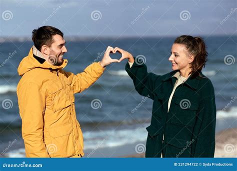 Happy Couple Making Hand Heart on Autumn Beach Stock Photo - Image of ...