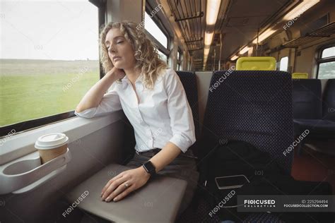 Tired businesswoman sleeping in train while travelling — laptop, Wireless Technology - Stock ...