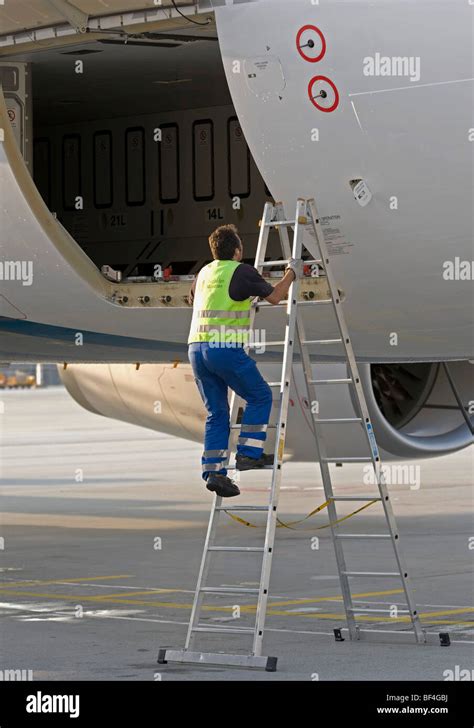 Ground crew working on a cargo door of an Airbus A330-200 of the Stock ...