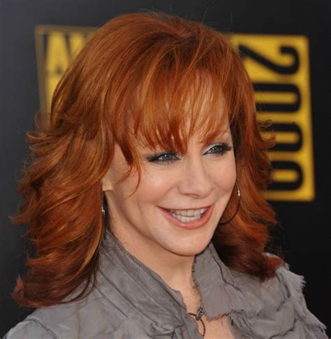 Reba McEntire's long chiseled red hair with a sculpted shape