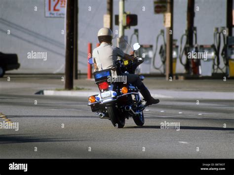 California Highway patrol officer on motor cycle motorcycle turns Stock Photo: 22670252 - Alamy