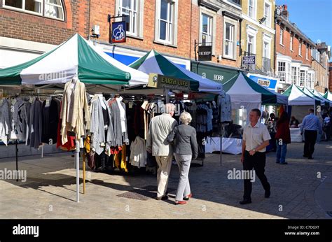 Shops and market stalls in Winchester High Street, Winchester, Hampshire, England on a quiet ...