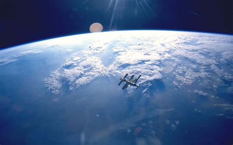 Download International Space Station (ISS) Orbiting Earth Wallpaper | Wallpapers.com