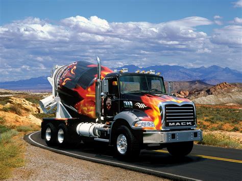 a large truck with flames painted on the side driving down a road in ...