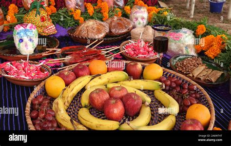 Day of the Dead altar (ofrenda) with food, sweets, sugar skulls and marigolds Stock Photo - Alamy