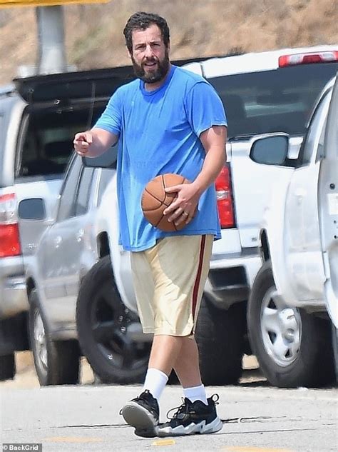 Adam Sandler works up a sweat while wearing an oversized tee and shorts ...