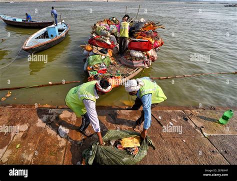 Workers from River Cleaning project collect garbage from the shores of ...