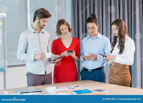 Business Executives Using Mobile Phones in Conference Room Stock Image ...