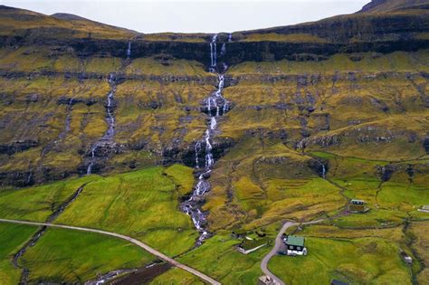 Premium Photo | Aerial view of waterfalls in the village of saksun on ...