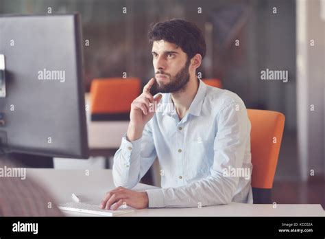 young business man working on desktop computer at his desk in modern ...