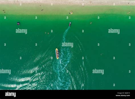 A Banana Boat Full of Tourists Speeding Away Stock Photo - Alamy