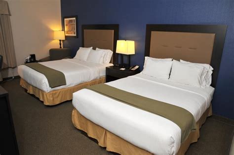 two beds in a hotel room with blue walls