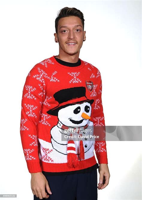 Mesut Ozil of Arsenal poses in the Arsenal Christmas Jumper during a... News Photo - Getty Images