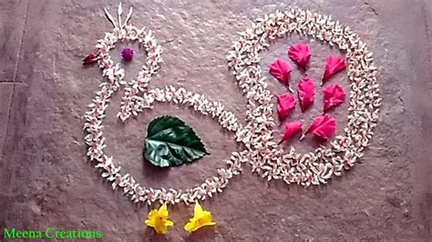 Peacock rangoli with parijatha flowers diwali rangoli with flowers ...