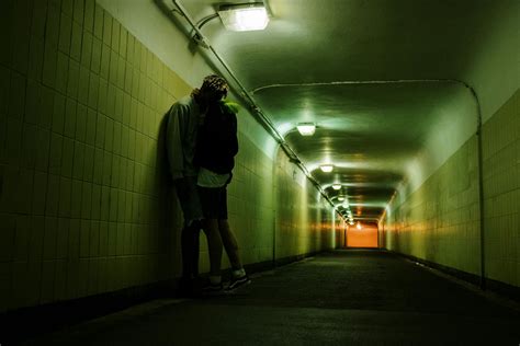 Man in Black Jacket and Black Shorts Walking on Hallway · Free Stock Photo