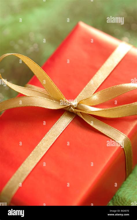 Red present with golden ribbon Stock Photo - Alamy