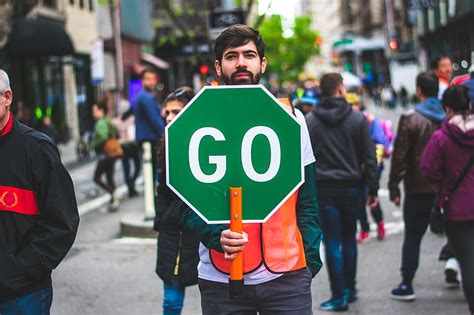 man, standing, road, holding, green, go, sign, action | Piqsels