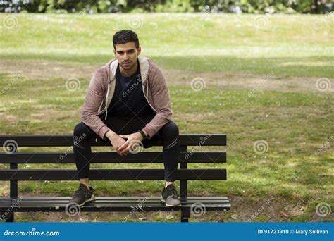 Fit Young Man Sitting on Bench in Park Stock Photo - Image of looking ...