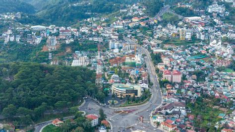 Aerial view of a Da Lat City with development buildings, transportation. Tourist city in ...