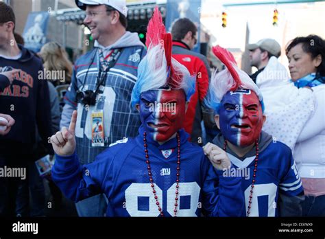 Young football fans with faces painted and dressed New York Giants fans ...