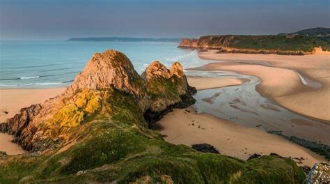 Three Cliffs Bay beach offers a wilder experience. Picture a ...