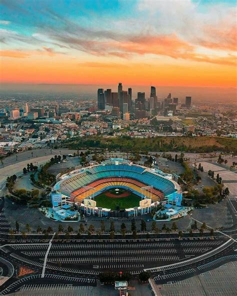 an aerial view of a baseball stadium with the city skyline in the ...