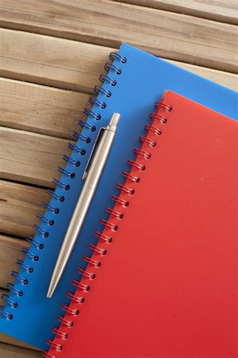Free Image of Pen and Notebook on Wooden Table | Freebie.Photography