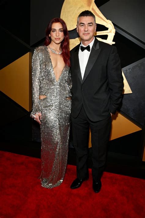 Dua Lipa stuns in a plunging silver gown as she makes rare appearance with dad at Grammys | HELLO!