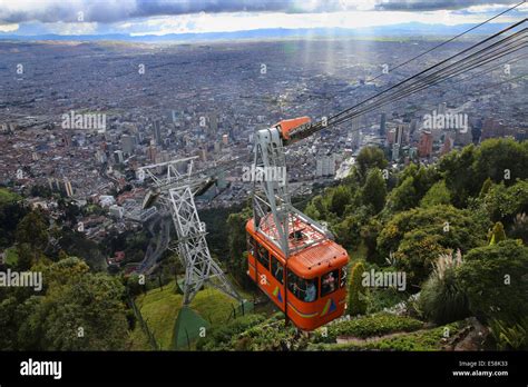 Teleferico (cable car) going up to Monserrate mountain peak. City of Bogota in the background ...