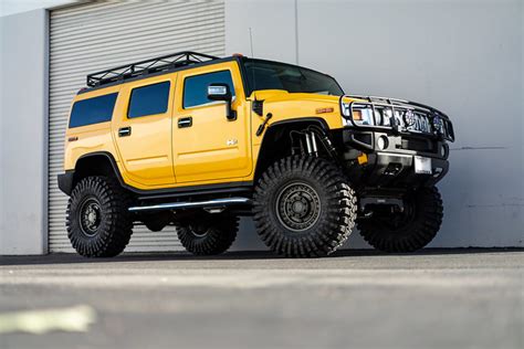 Yellow lifted Hummer H2 on Black Rhino Armory gunblack gunmetal military 17 inch off road wheels ...