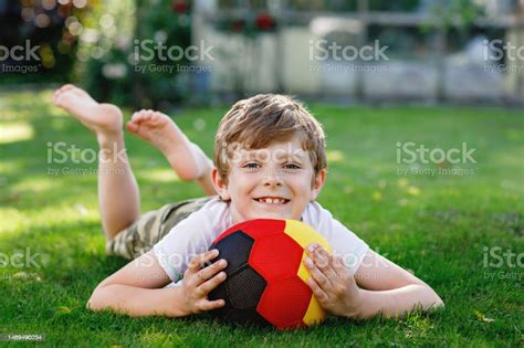 Happy Active Kid Boy Playing Soccer With Ball In German Flag Colors Healthy Child Having Fun ...