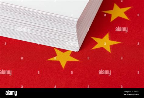 Ream of printer paper and China flag. Paper products industry, trade ...