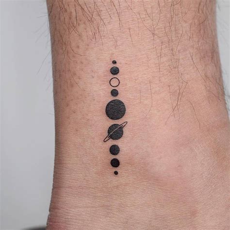Minimalist solar system tattoo on the ankle