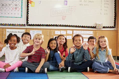 Elementary school kids sitting on classroom floor - Stock Photo - Dissolve