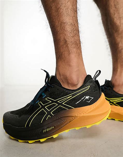 Asics Trabuco Max 2 running trainers in black and orange | ASOS