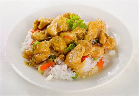 Chicken Curry and rice on a white plate. - Waiter.com Food Delivery Blog