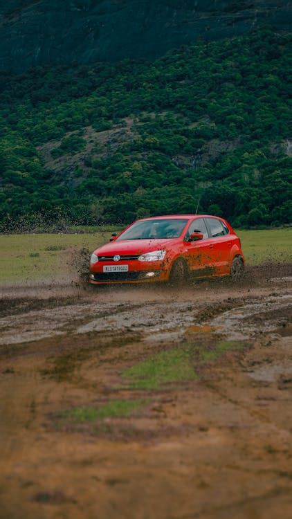 Red Volkswagen Car on Dirt Road · Free Stock Photo