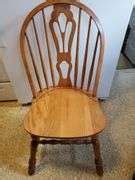 40-in round solid wood dining table with four matching spindle back chairs. Also includes one ...