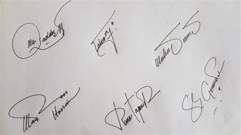 several autographed items are displayed on a piece of paper that has ...