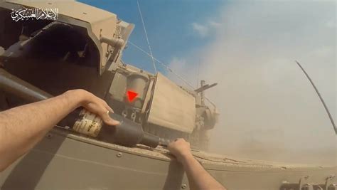 Video seems to show Hamas fighter running up to an Israeli tank, planting an explosive on it ...