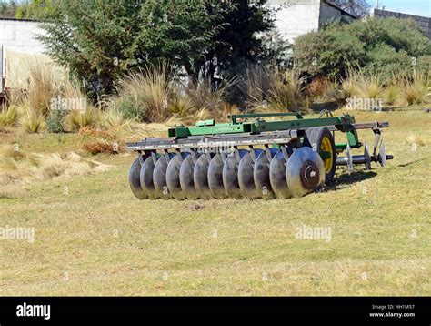 Disc harrow farm equipment in field in rural village Stock Photo - Alamy