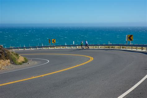 Two cyclists enjoy the view of the whitecaps on the Pacific Ocean near Windermere Point ...