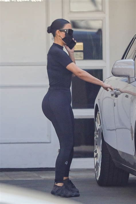 Kim Kardashian shows off her famous curves in skintight leggings as she rocks ex Kanye West's ...