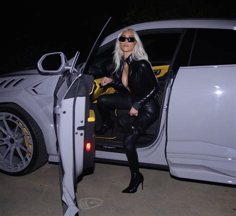 Kim Kardashian nearly busts out of skintight leather catsuit while exiting her $250K Lamborghini ...