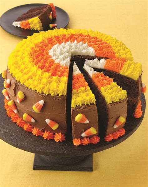 a cake that has been decorated with candy corn and chocolate frosting on the top