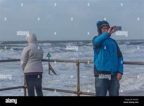 West Wittering. 21st Oct, 2017. UK Weather. People taking a selfie with Storm Brian at West ...