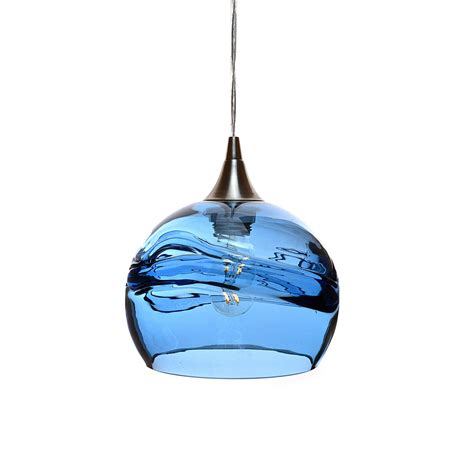 a blue glass light hanging from a ceiling