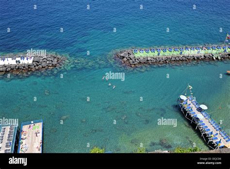 The view from Sorrento of the Marina Grande beach and sunbathing facilities and Bay of Naples ...