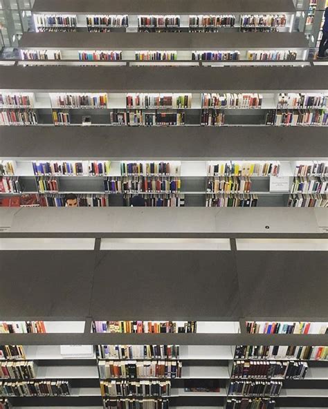 several rows of shelves filled with books in a public library or book ...