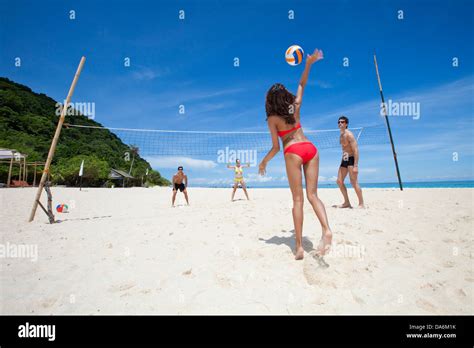 Friends playing beach volleyball Stock Photo - Alamy